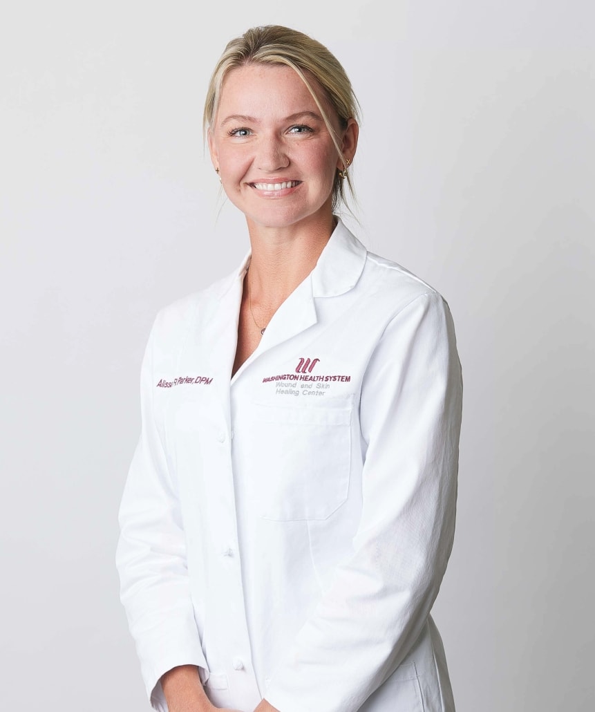 Dr. Parker in white lab coat, smiling