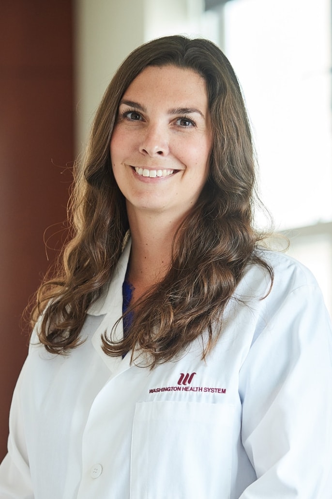Dr. Lauren O'Brien in lab coat smiling