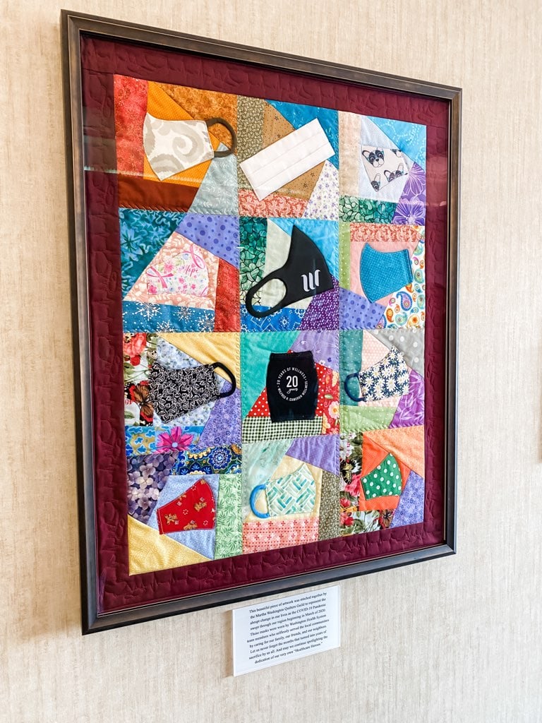 close up photo of framed quilt made of pandemic masks