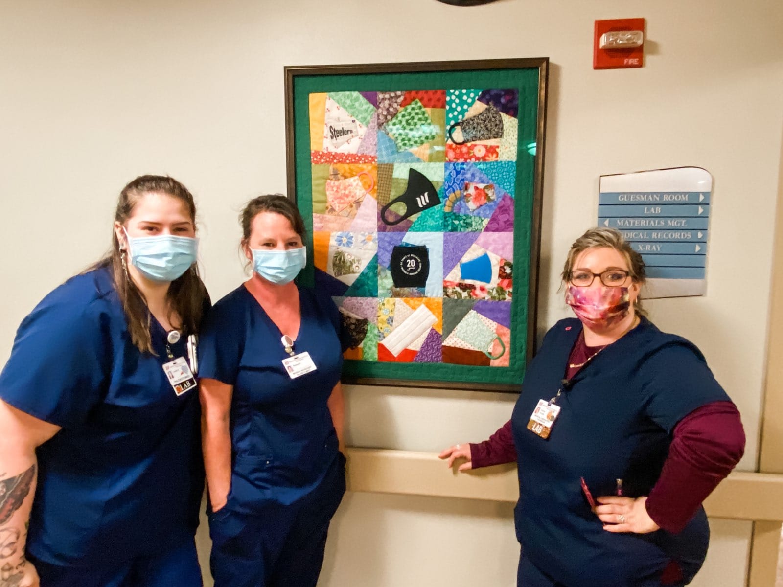 photo of three employees with WHS Greene mask quilt