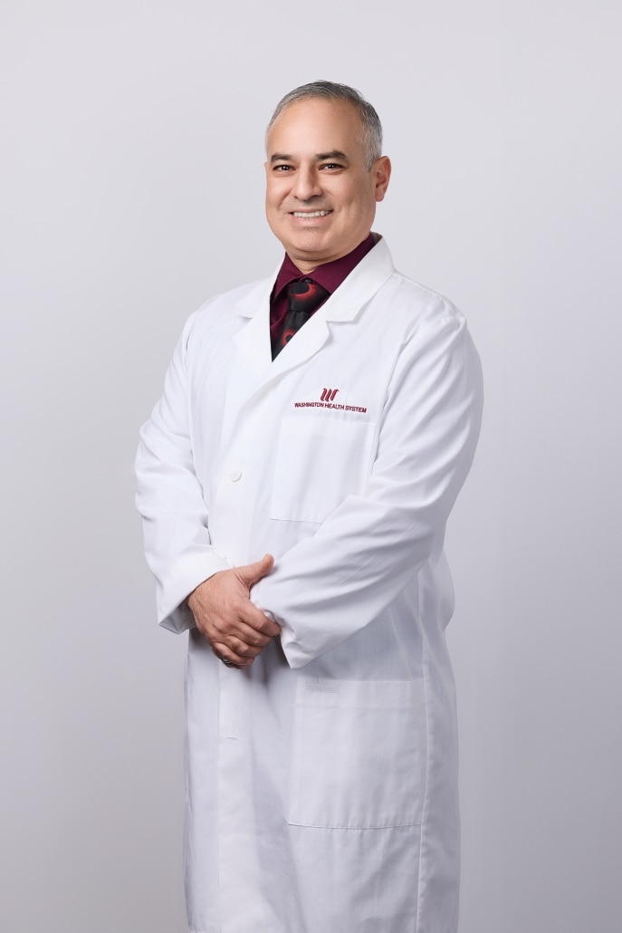 Dr. Gonzalez-Ortiz in a white lab coat
